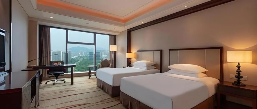 Bed in New Century Grand Hotel Zhejiang Sanli