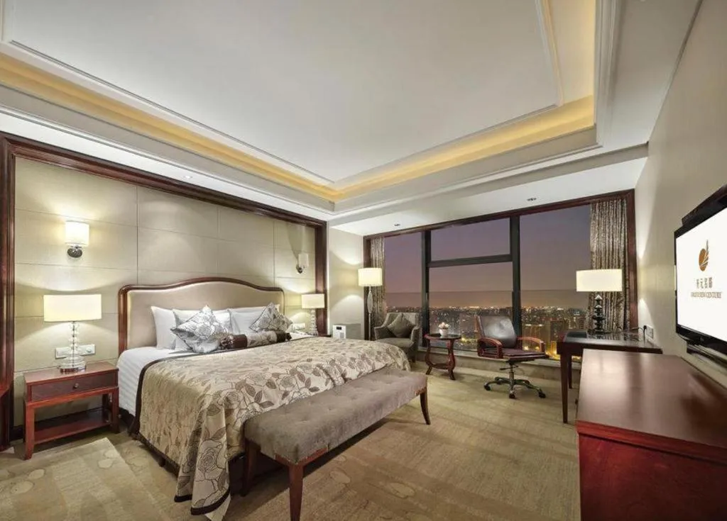 Bed in New Century Grand Hotel Zhejiang Sanli