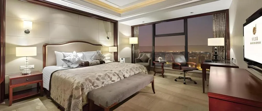 Bed in New Century Grand Hotel Zhejiang Sanli