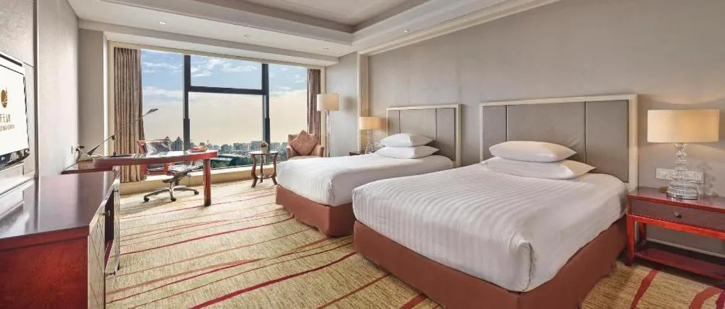 Bed in New Century Grand Hotel Zhejiang Sanli