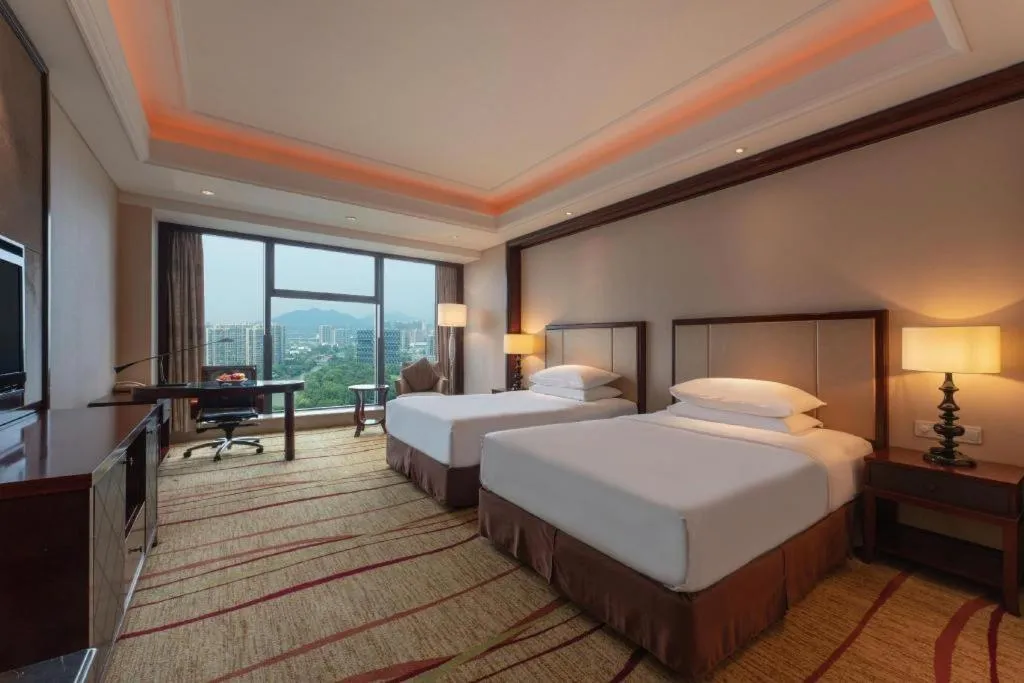 Bed in New Century Grand Hotel Zhejiang Sanli