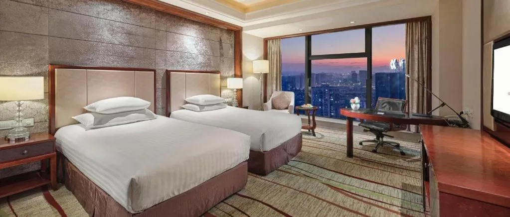 Bed in New Century Grand Hotel Zhejiang Sanli