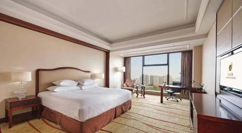 Bed in New Century Grand Hotel Zhejiang Sanli