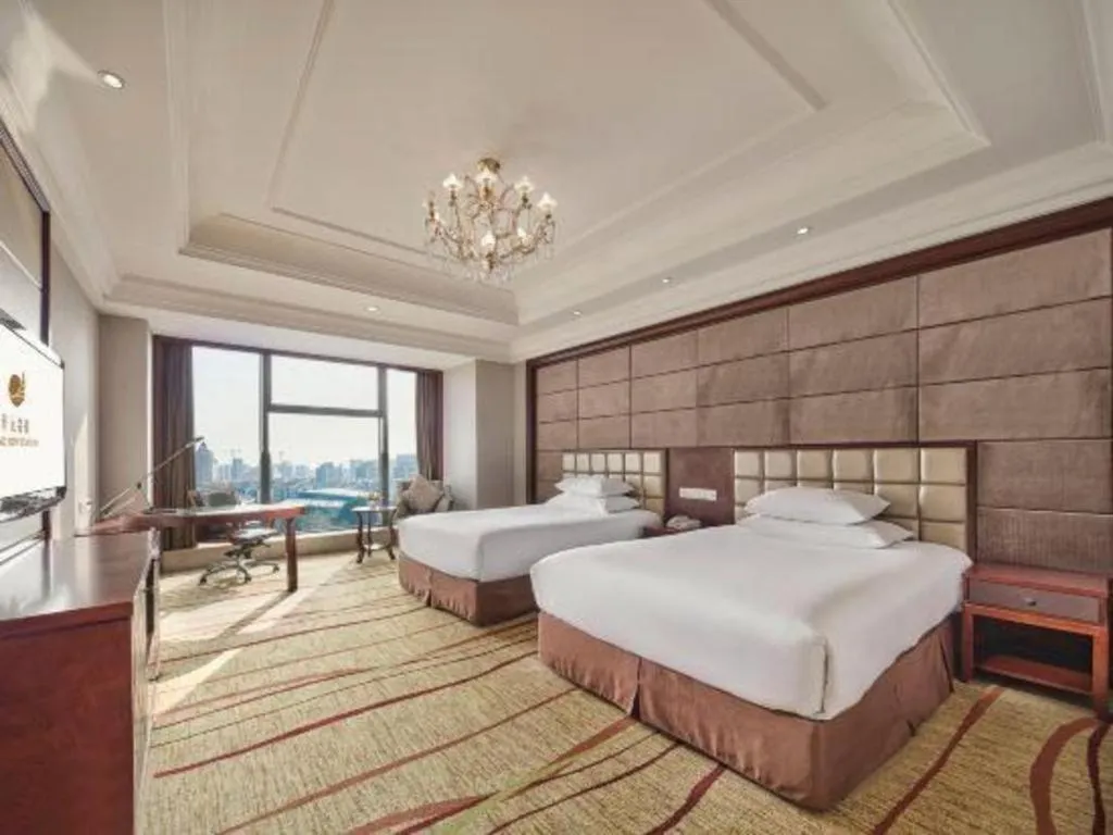Bed in New Century Grand Hotel Zhejiang Sanli