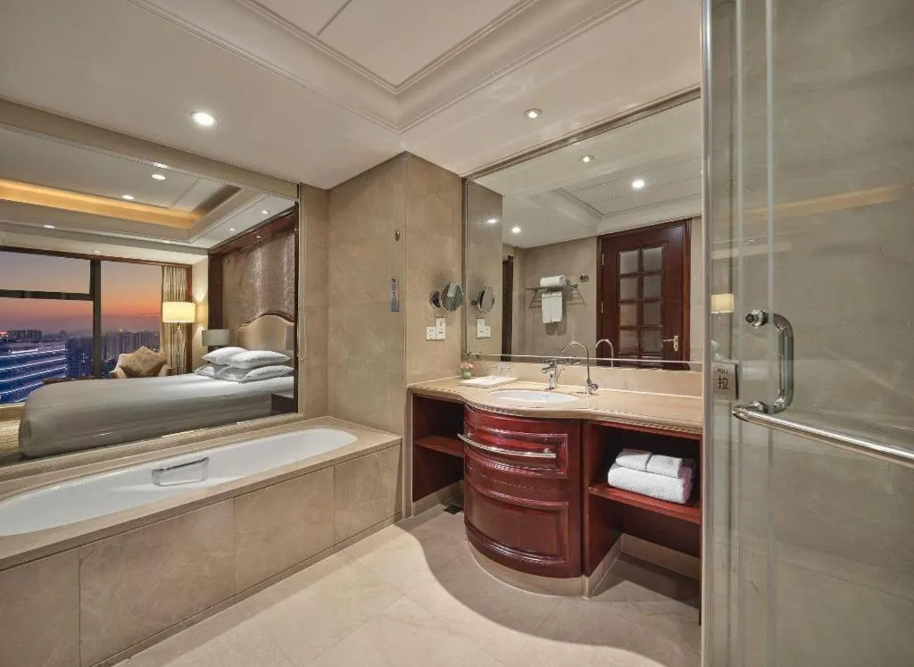 Bed in New Century Grand Hotel Zhejiang Sanli