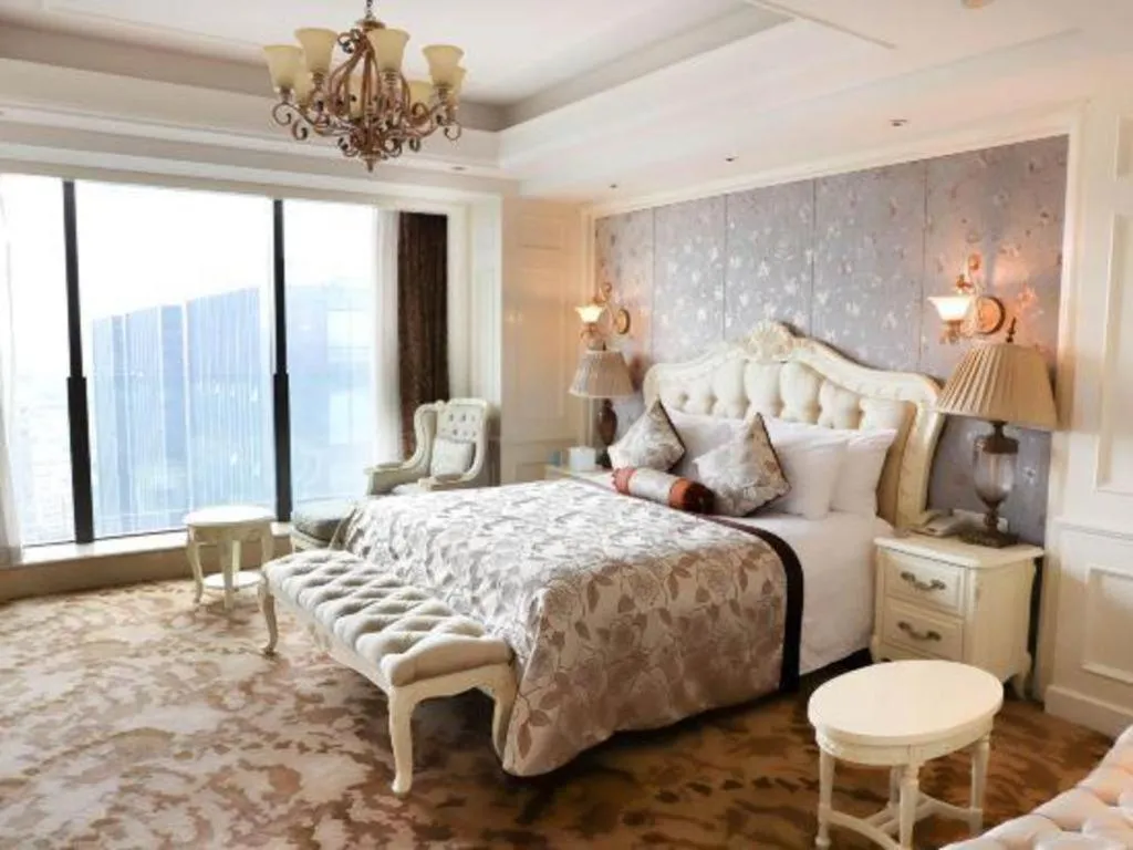 Bed in New Century Grand Hotel Zhejiang Sanli