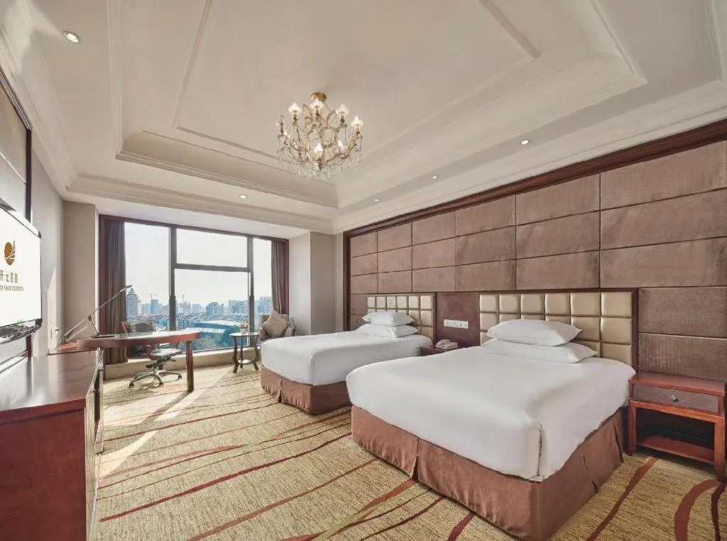 Bed in New Century Grand Hotel Zhejiang Sanli