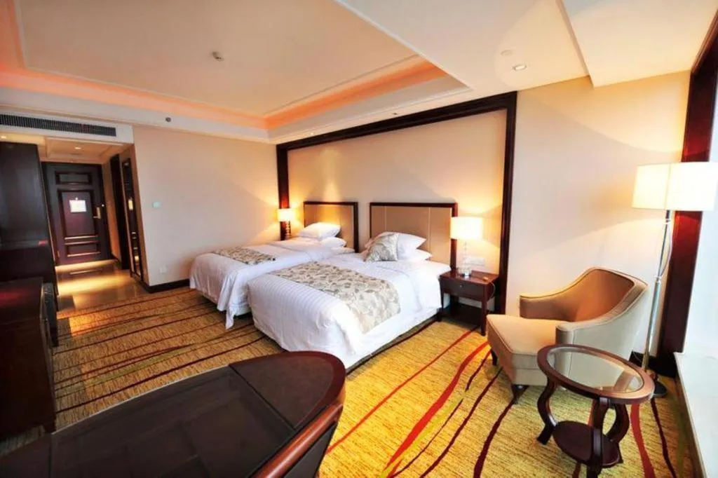 Bed in New Century Grand Hotel Zhejiang Sanli