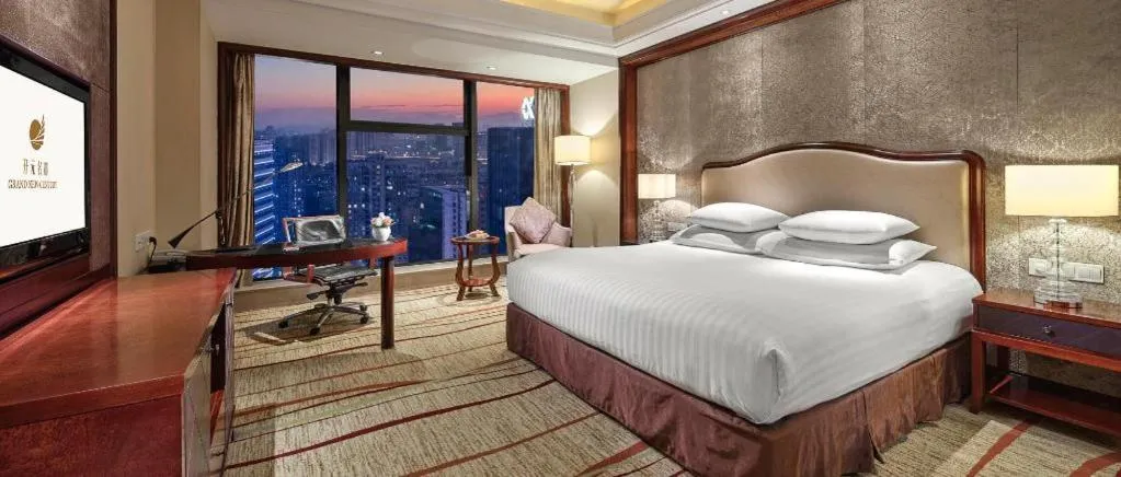 Bed in New Century Grand Hotel Zhejiang Sanli