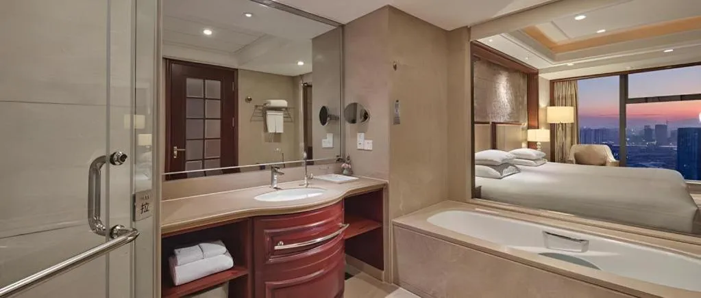 Bed in New Century Grand Hotel Zhejiang Sanli