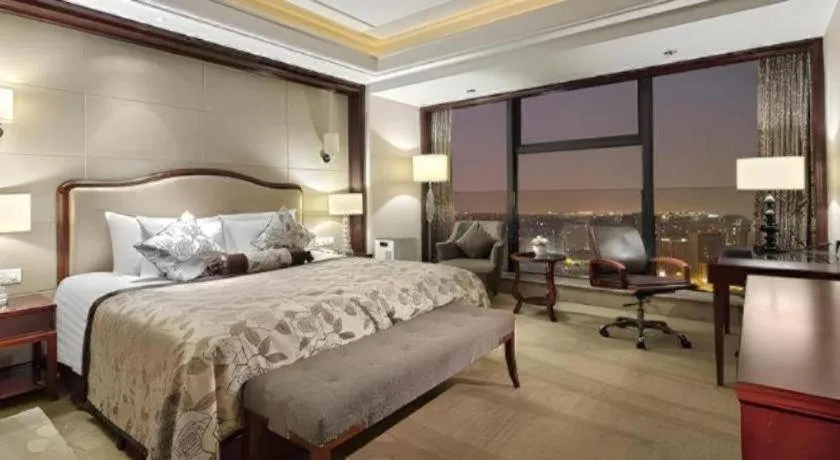 Bed in New Century Grand Hotel Zhejiang Sanli