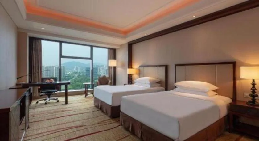 Bed in New Century Grand Hotel Zhejiang Sanli