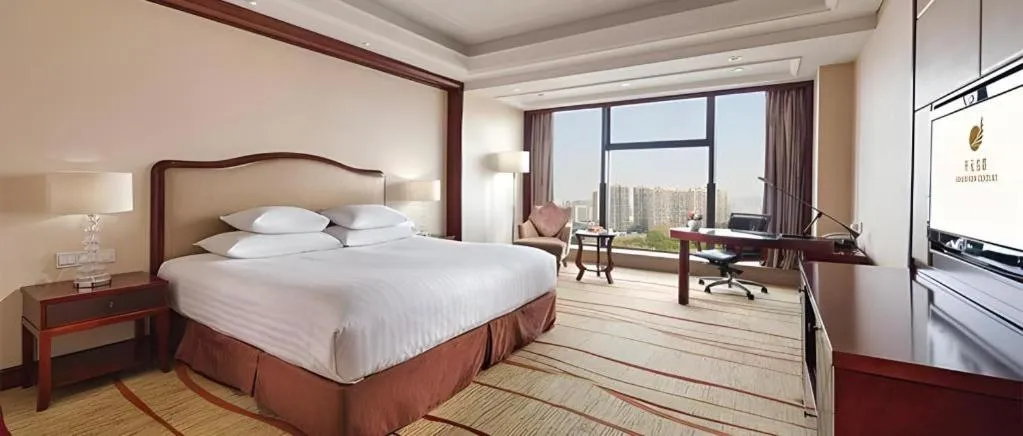 Bed in New Century Grand Hotel Zhejiang Sanli