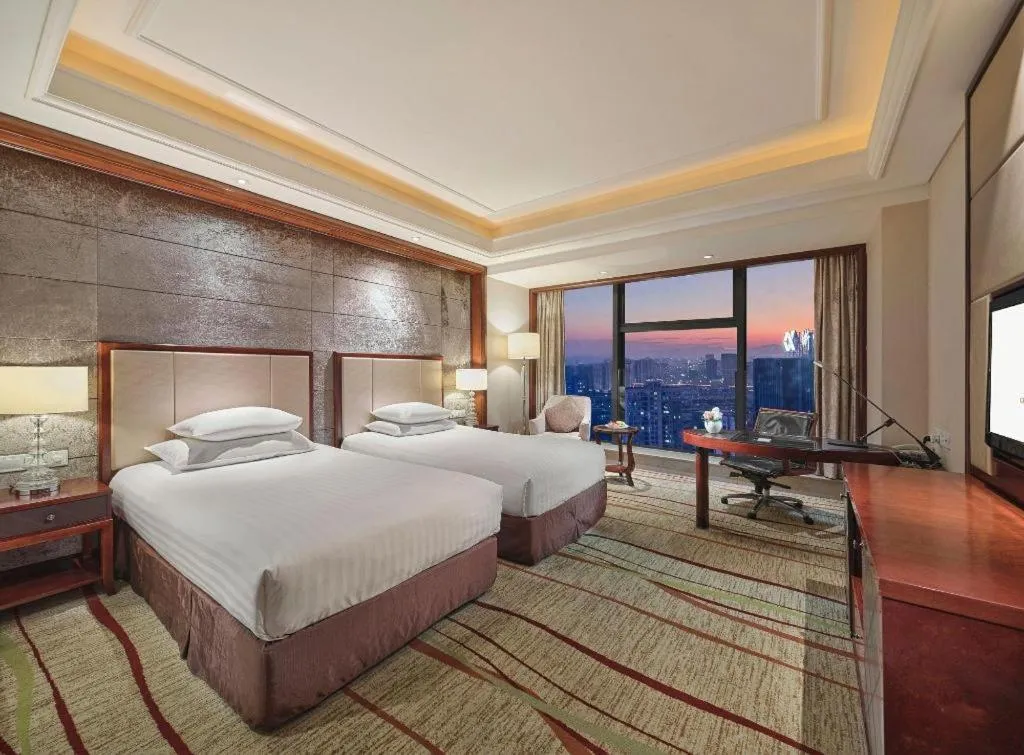 Bed in New Century Grand Hotel Zhejiang Sanli