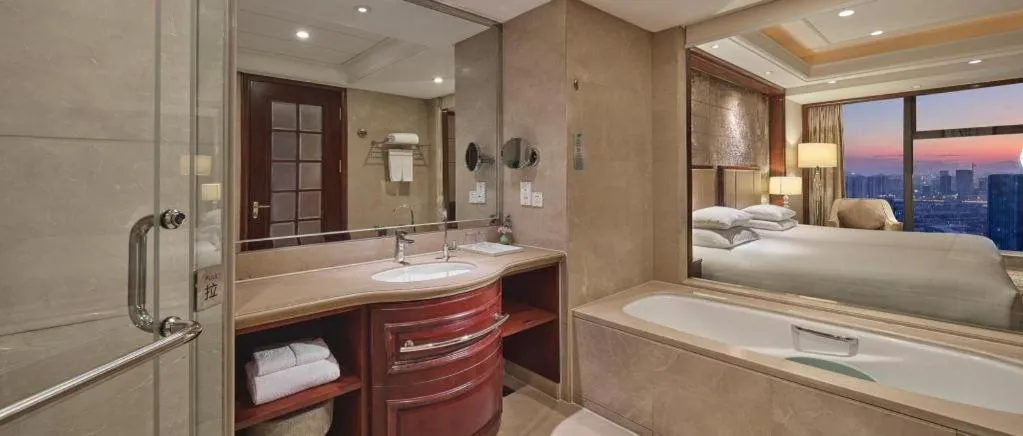 Bed in New Century Grand Hotel Zhejiang Sanli