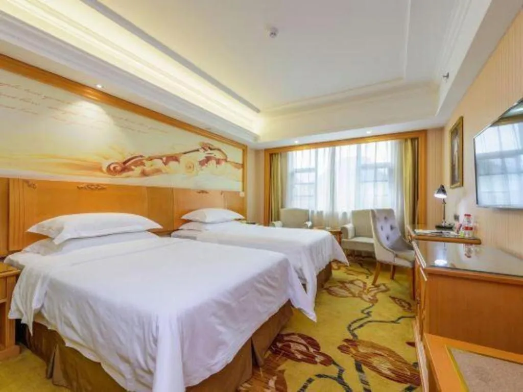 Bed in Vienna Hotel Guangxi Liuzhou Xijiang Vientiane City