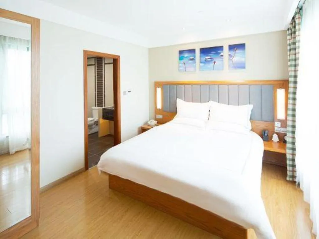 Bed in Warmly Hotel Suzhou Shuanghuwan