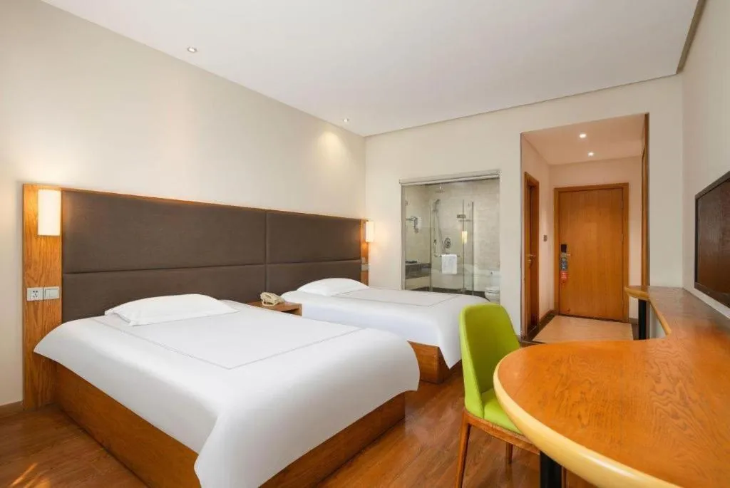 Bed in Warmly Hotel Suzhou Shuanghuwan