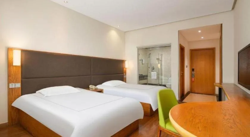 Bed in Warmly Hotel Suzhou Shuanghuwan