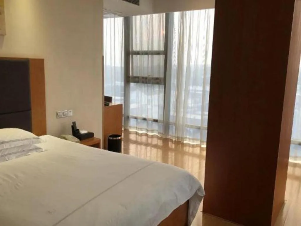 Bed in Warmly Hotel Suzhou Shuanghuwan