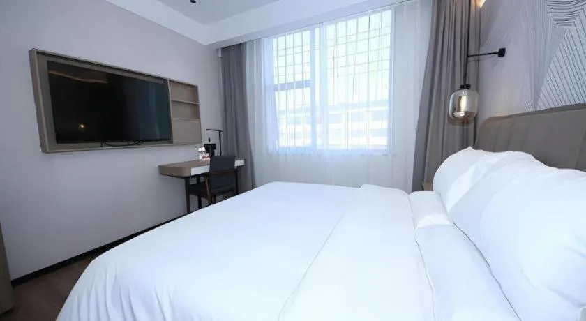 Bed in JUNYI Hotel Jiangxi Xinyu Baoshi Park