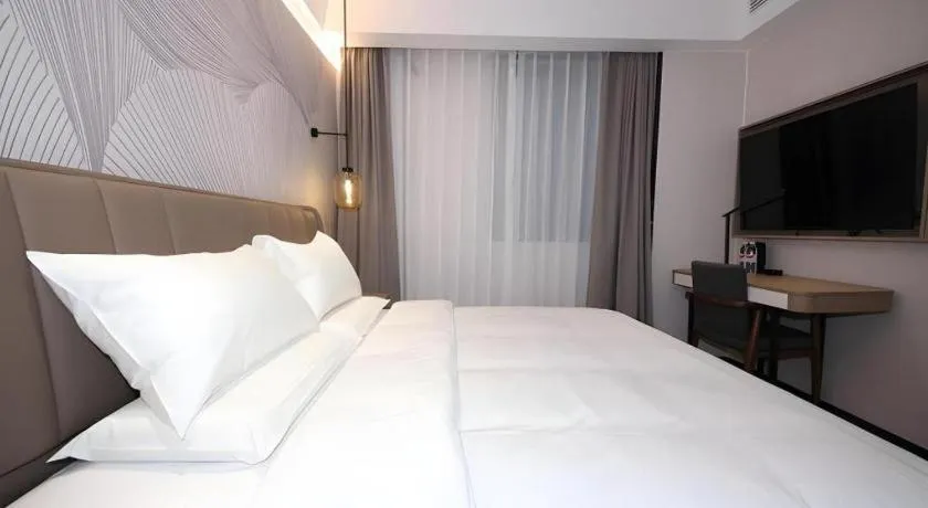 Bed in JUNYI Hotel Jiangxi Xinyu Baoshi Park