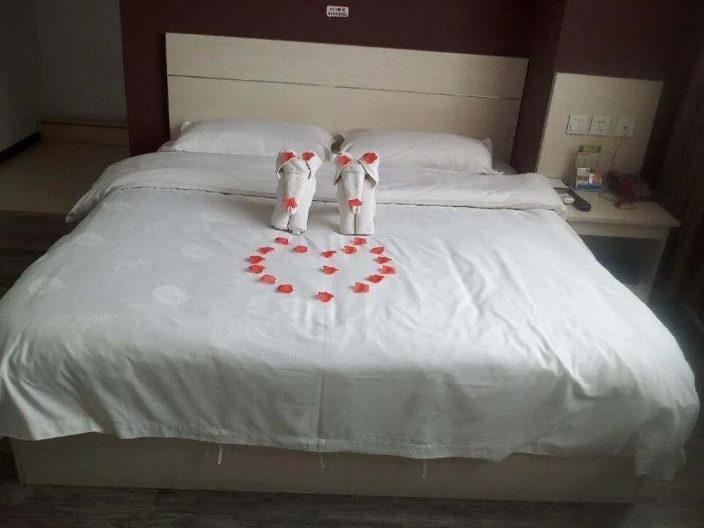 Bed in JUNYI Hotel Jiangxi Xinyu Baoshi Park