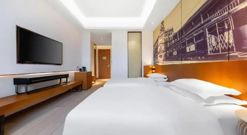 Bed in Jinjiang Metropolo Hotel Shanghai Hongqiao International Exhibition Center Branch
