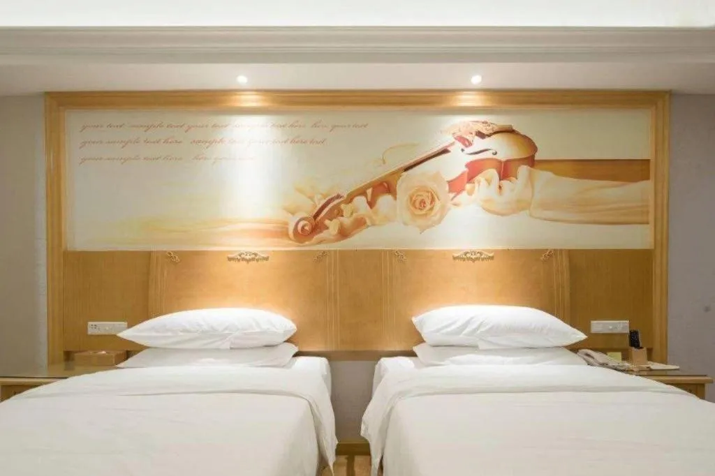 Bed in Vienna Hotel Shenzhen Longgang Baifucheng