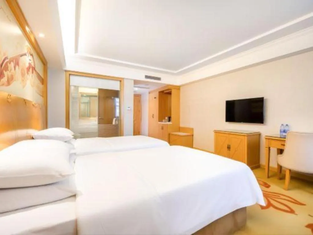 Bed in Vienna Hotel Shenzhen Longgang Baifucheng