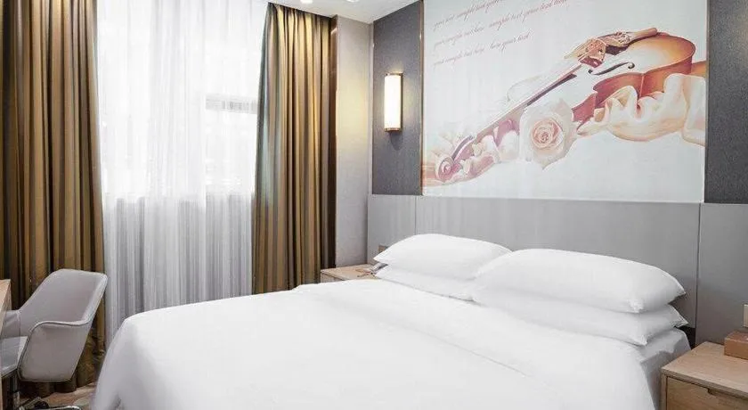 Bed in Vienna Hotel Guangdong Huizhou Lilin North Railway Station