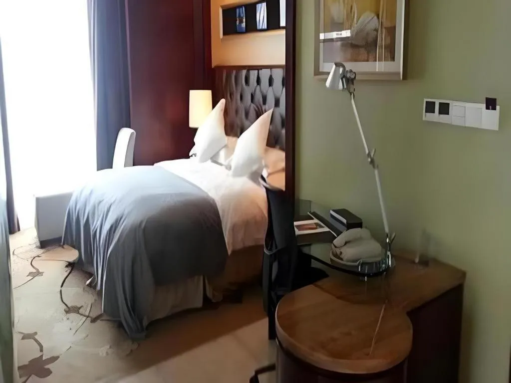 Bed in Maison New Century Hotel Wuyuan Haiyan