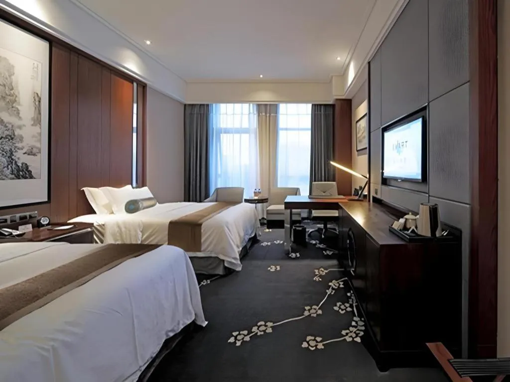 Bed in Jiyuan Oriental Jianguo Hotel