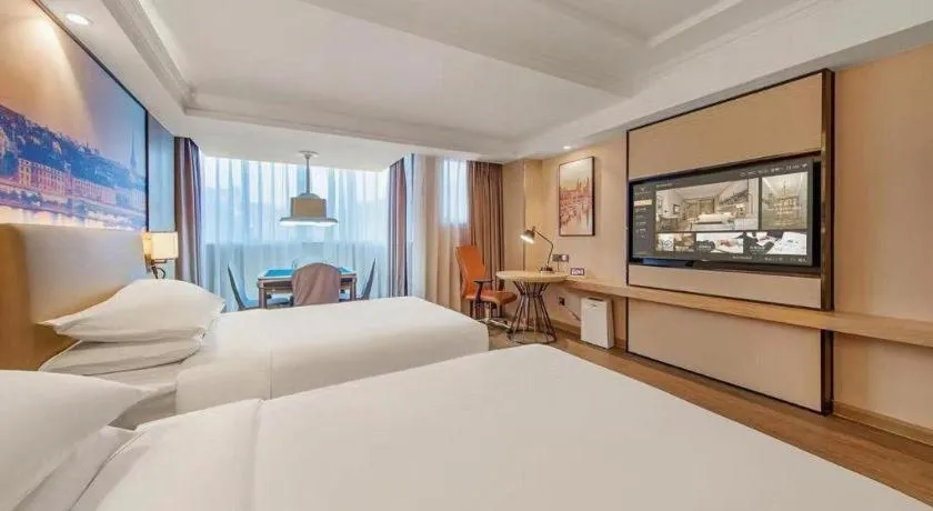 Bed in Vienna International Hotel Guangzhou Baiyun Dayuanli Plaza