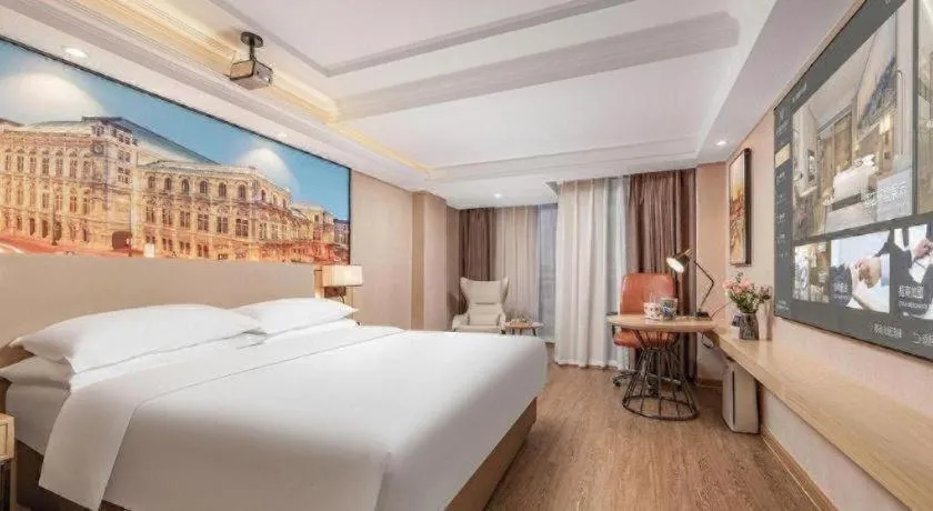 Bed in Vienna International Hotel Guangzhou Baiyun Dayuanli Plaza