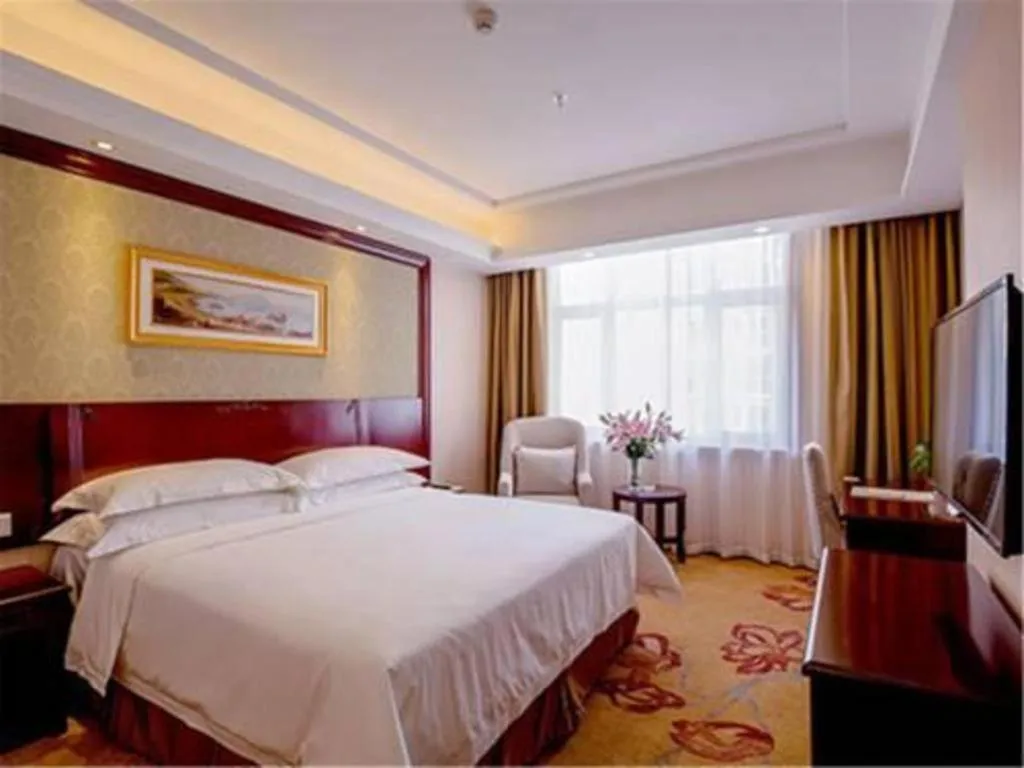 Bed in Vienna International Hotel Guangzhou Baiyun Dayuanli Plaza