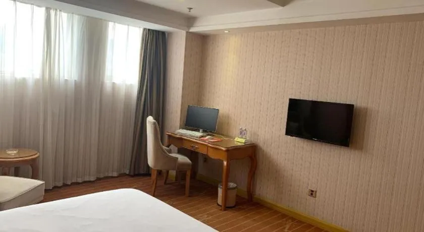 Bed in Vienna International Hotel Guangzhou Baiyun Dayuanli Plaza