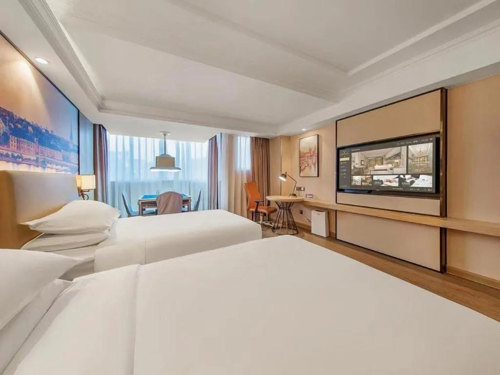 Bed in Vienna International Hotel Guangzhou Baiyun Dayuanli Plaza