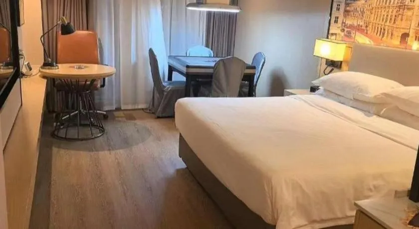 Bed in Vienna International Hotel Guangzhou Baiyun Dayuanli Plaza