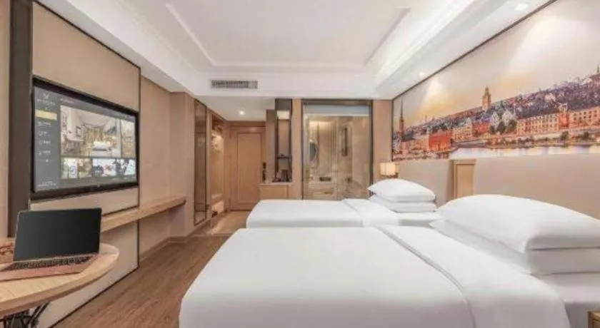 Bed in Vienna International Hotel Guangzhou Baiyun Dayuanli Plaza