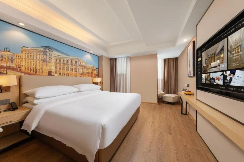 Bed in Vienna International Hotel Guangzhou Baiyun Dayuanli Plaza