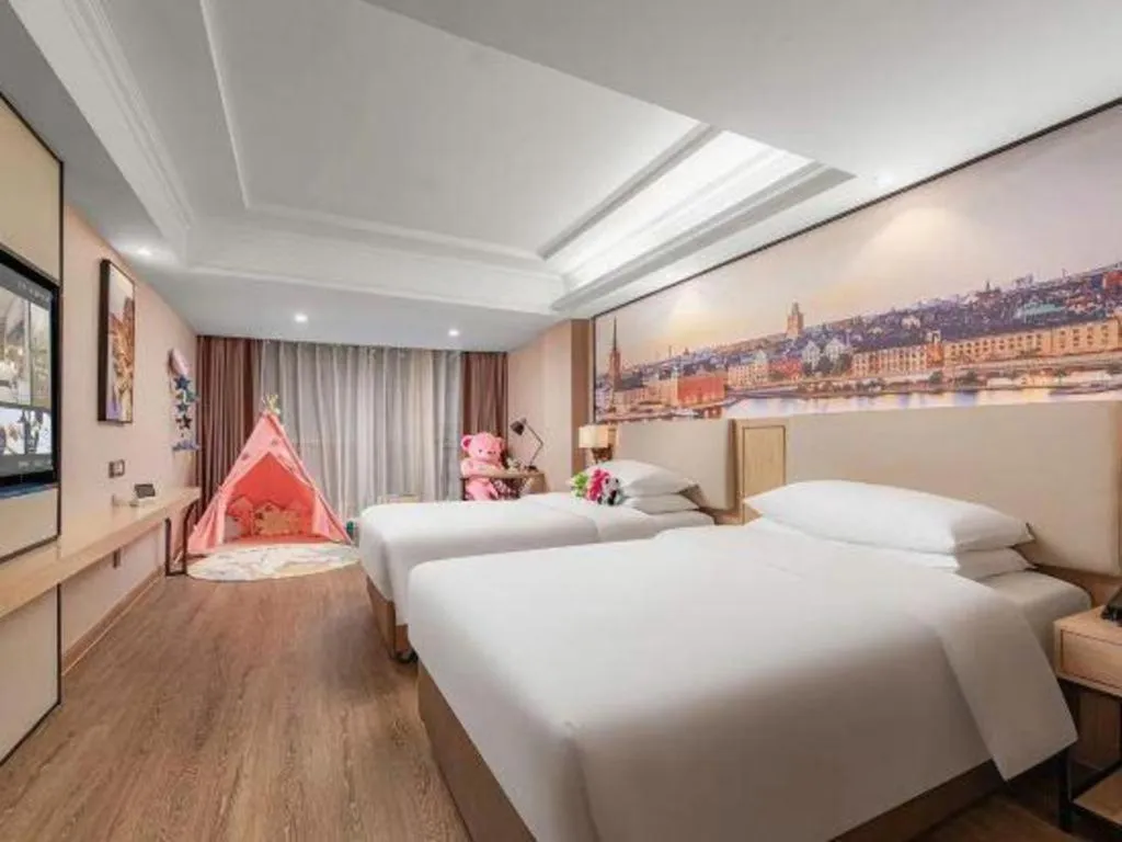 Bed in Vienna International Hotel Guangzhou Baiyun Dayuanli Plaza