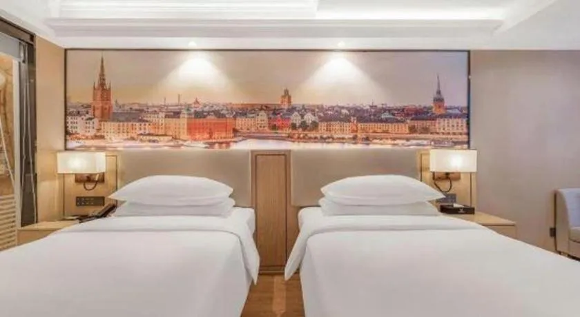 Bed in Vienna International Hotel Guangzhou Baiyun Dayuanli Plaza