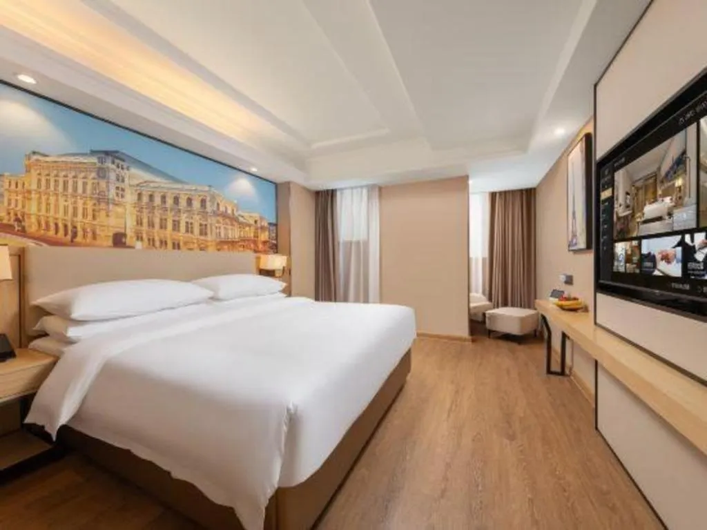 Bed in Vienna International Hotel Guangzhou Baiyun Dayuanli Plaza