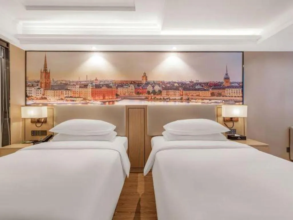 Bed in Vienna International Hotel Guangzhou Baiyun Dayuanli Plaza