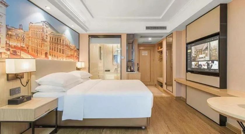 Bed in Vienna International Hotel Guangzhou Baiyun Dayuanli Plaza