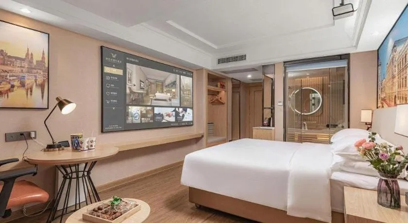 Bed in Vienna International Hotel Guangzhou Baiyun Dayuanli Plaza