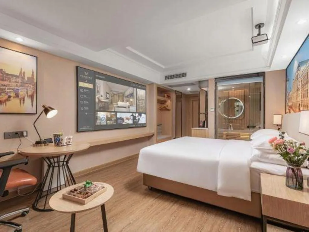 Bed in Vienna International Hotel Guangzhou Baiyun Dayuanli Plaza