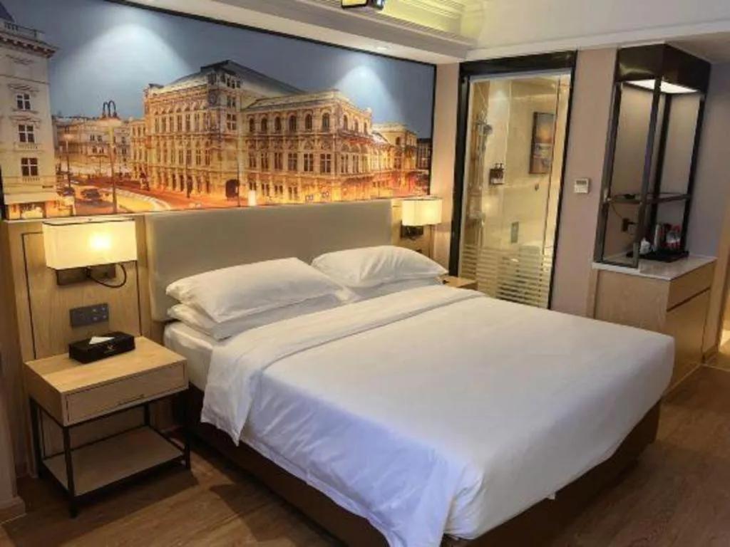 Bed in Vienna International Hotel Guangzhou Baiyun Dayuanli Plaza