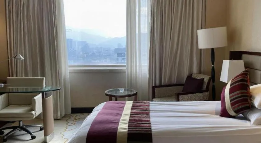 Bed in New Century Grand Hotel Lishui Huaqiao